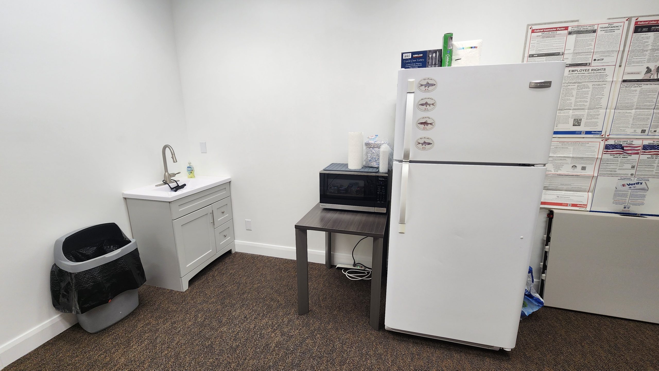 Former Stantec St. George kitchenette with stand-alone sink and carpeted floor