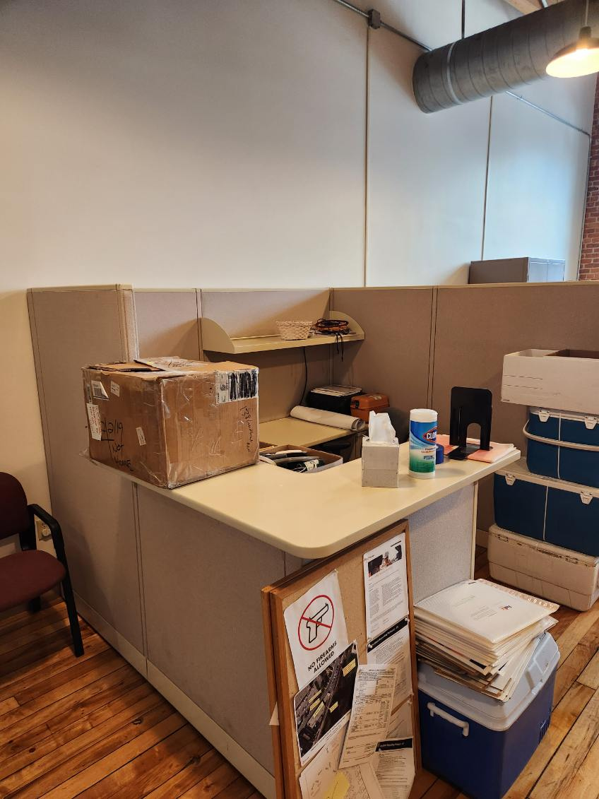 Existing workstation furniture before teardown and reconfiguration